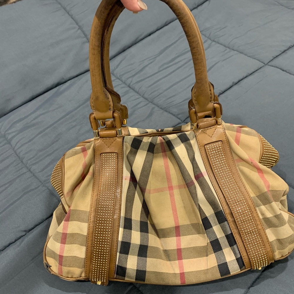 Burberry Bag With Gold Grommets, an overnight bag.